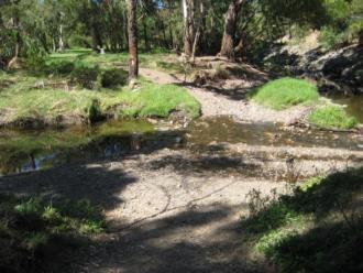 Christmas Day 2011 floods has led to large amount of sediment and small rocks deposited into middle of creek. This has created a dam effect. On opposite bank erosion has formed a new overland flow route. Both banks severely scoured by flood water.