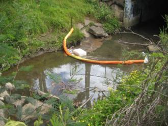 litter trap strung across the waterway at YDI847